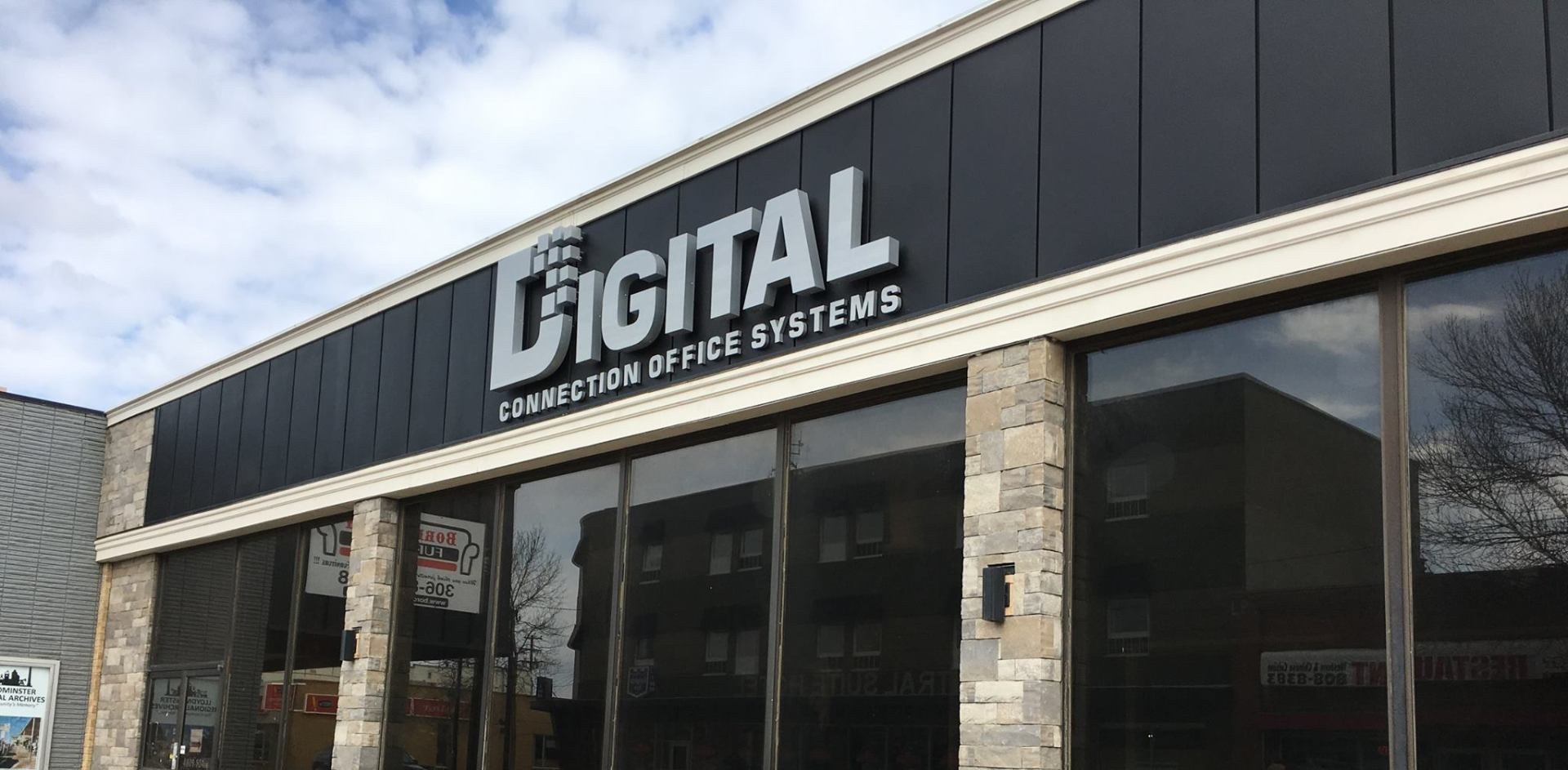 The front of a building with a sign that says digital on it.
