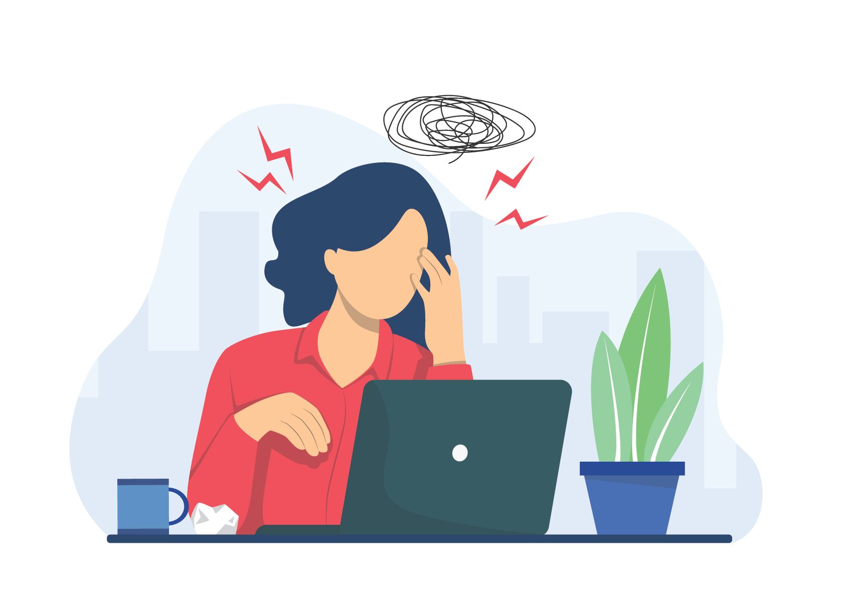 A woman is sitting at a desk in front of a laptop computer.