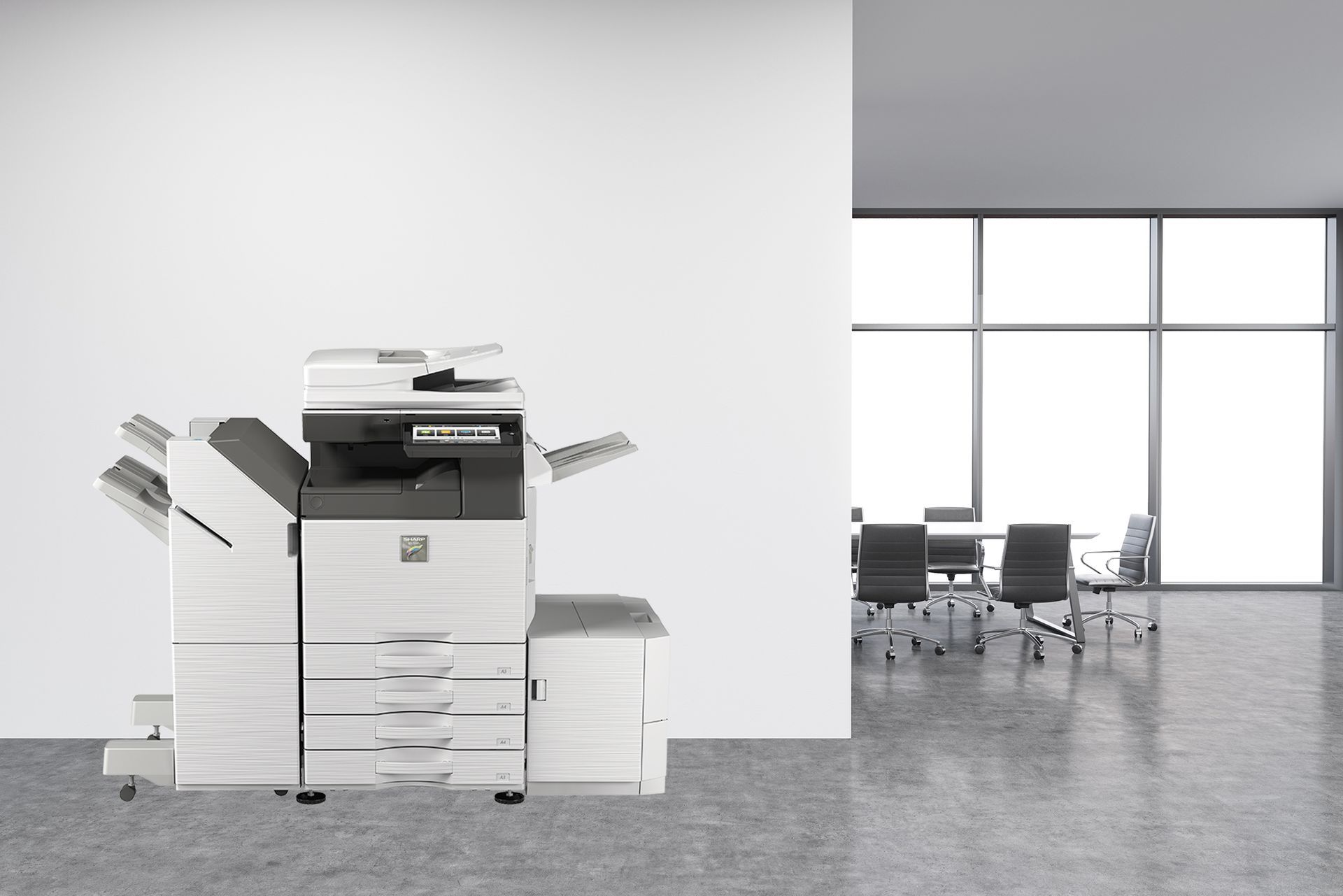 A black and white printer is sitting in an office next to a conference room.