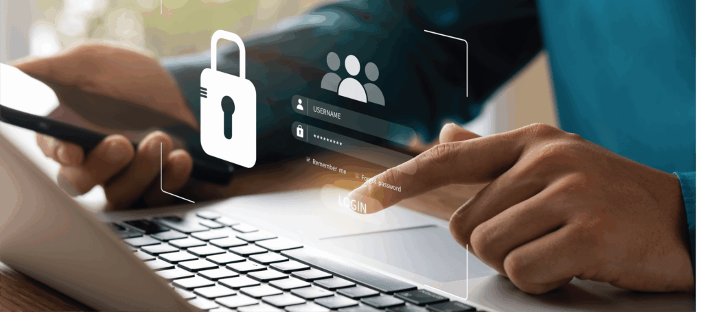 A person is using a laptop computer while holding a cell phone.