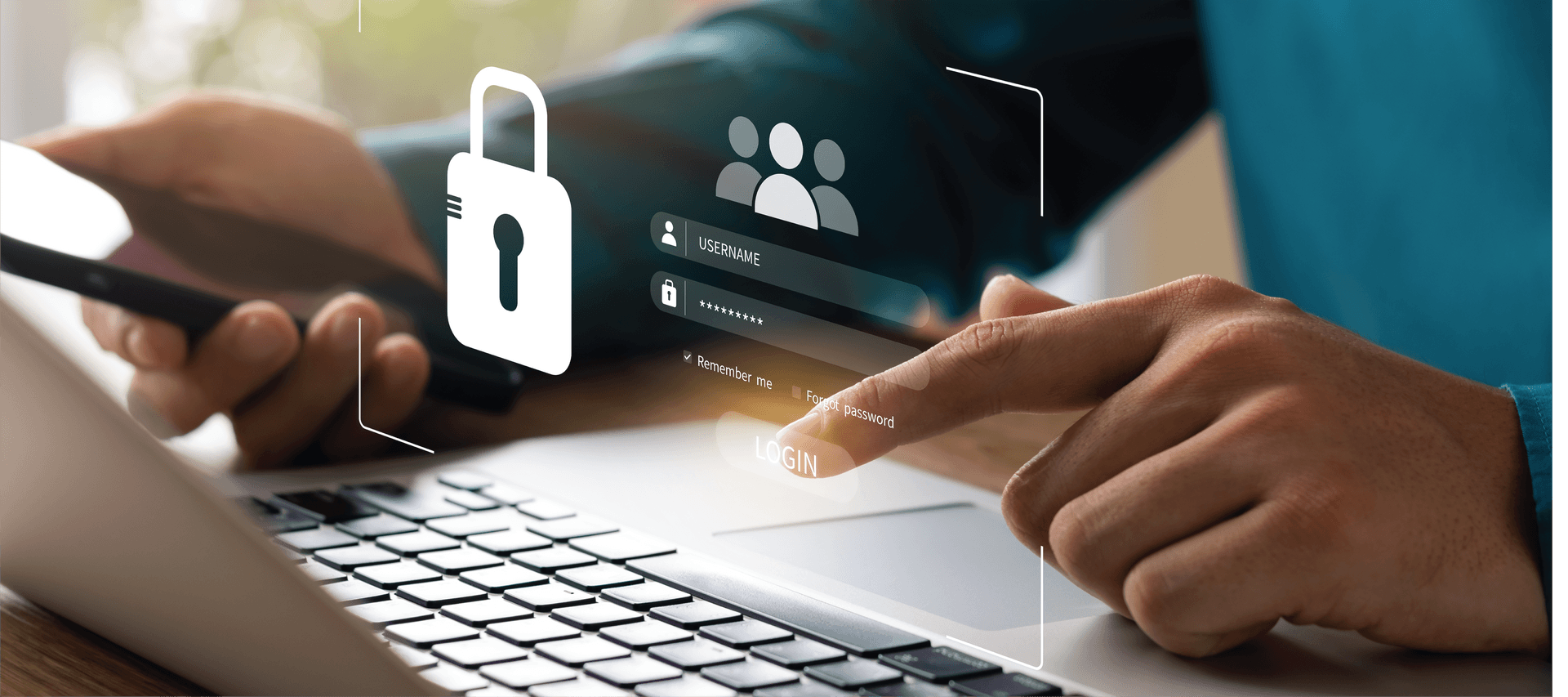 A person is using a laptop computer while holding a cell phone.