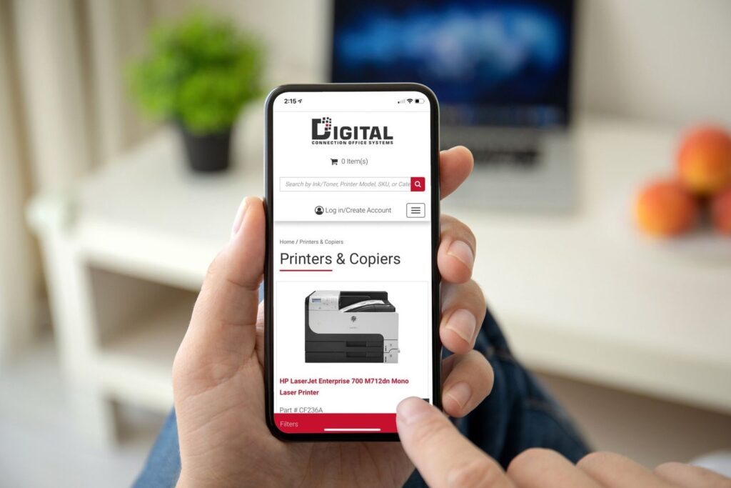 A person is holding a cell phone with a digital website on it