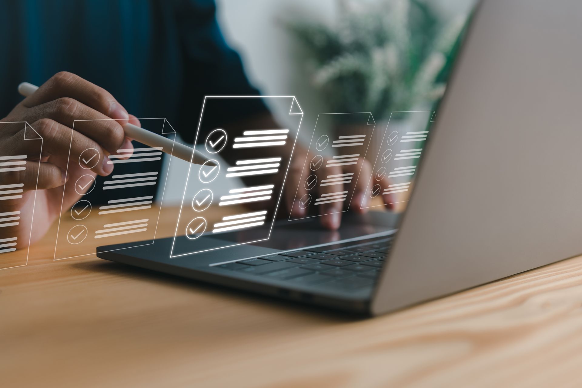 A person is using a laptop computer with a pen.